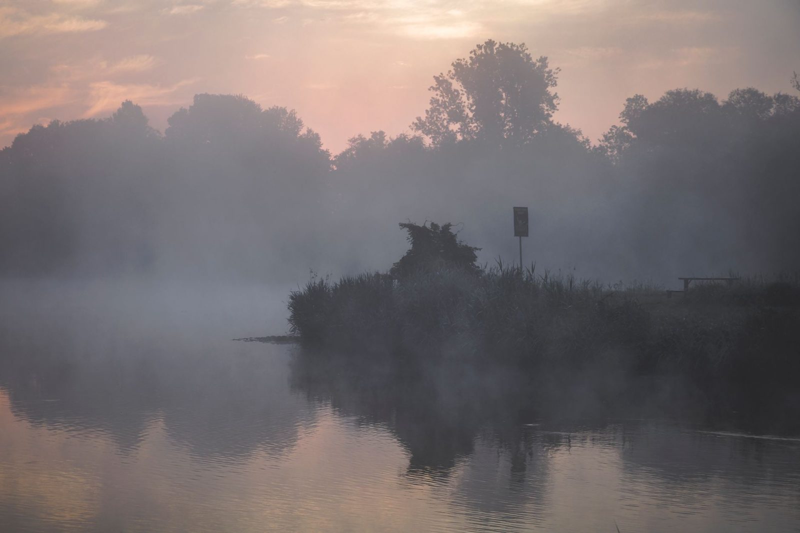 Still water and soft mist at first light